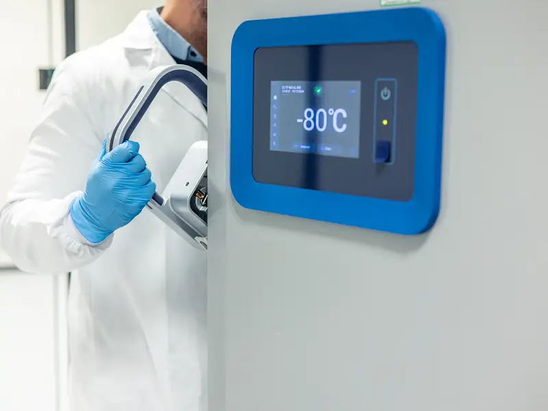 Digital temperature display on a laboratory freezer unit for research compound storage.